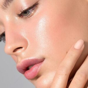 Close-up of glowing, hydrated skin with natural shine showing smooth texture after applying glow serum
